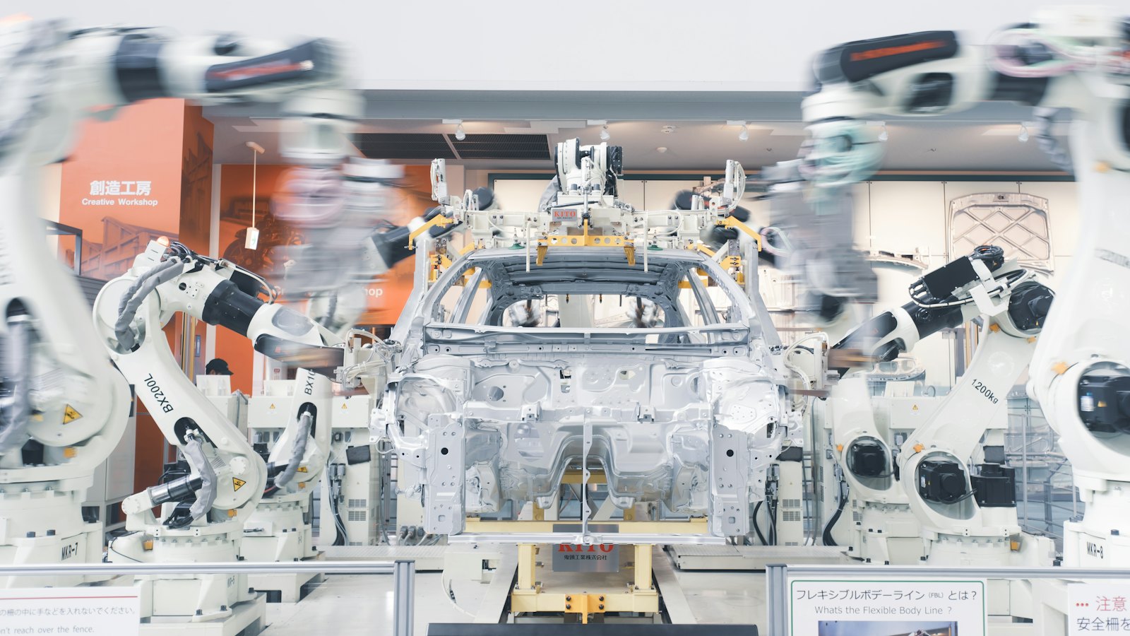 Robotic arms assembling a car chassis on a factory line